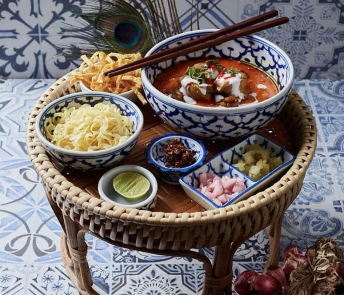 A spread of Thai curries and rice on a tiered stand at Baan Rao